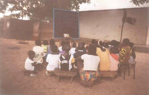 Our children's ministration outreach in Guinea-Bissau studying under a mango tree.
